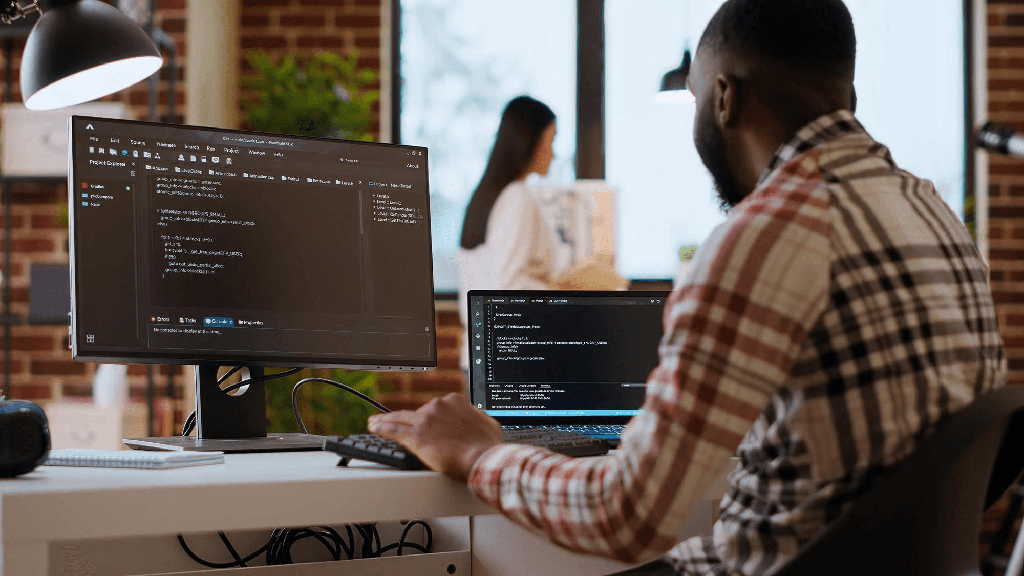 Development team working on coding projects with multiple monitors